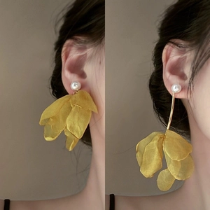 Elegant yellow fabric flower petal earrings with pearl studs shown on model for women