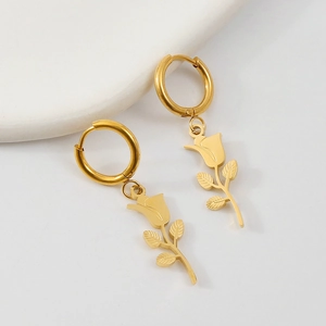 Close-up of golden rose pendant hoop earrings made of vacuum-plated stainless steel