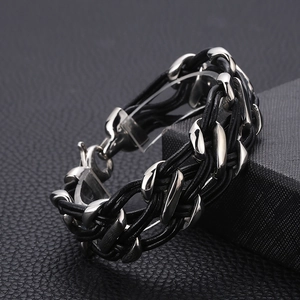 Detailed view of woven black leather cord bracelet with polished stainless steel clasp