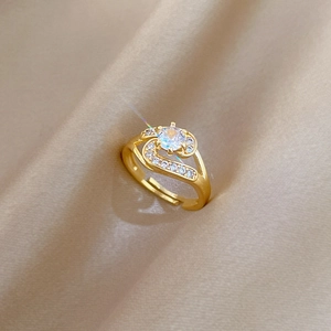 Luxurious gold-plated open ring with shimmering pavé zircon stones on champagne silk