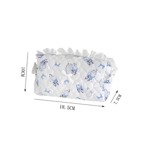 Detail showing dimensions of the white quilted cosmetic bag with blue cat pattern