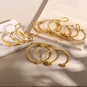 Minimalist 18K gold stainless steel open bangles with cross and knot designs on stone