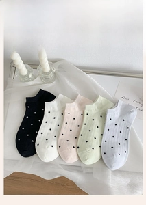Detailed set of five polka dot ankle socks in various colors on elegant white fabric
