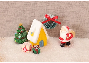 Miniature Christmas set with snow house, Santa Claus, and resin trees on fake snow