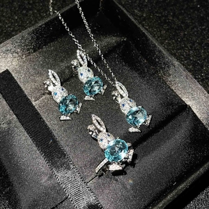 Detailed jewelry set with blue heart topaz and crystal rabbit design in a black box