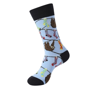 Detailed close-up of blue cotton mid-calf socks with cute sloth and colorful patterns