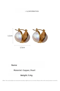 Detail view of gold-plated copper earrings with double large white pearls for women
