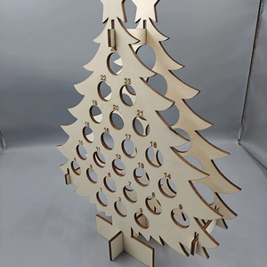 Close-up of wooden Christmas tree countdown wine rack with 24 numbered holes for bottles