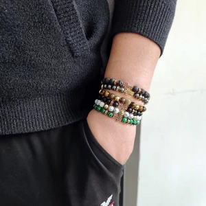 Men's beaded bracelet set with tiger eye, volcanic rock, and golden cross charm