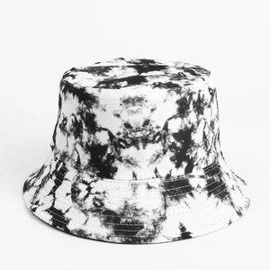 Detailed view of tie-dye bucket hat stitching and black white splatter canvas texture