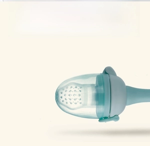Close-up of mint green baby fruit feeder silicone nipple with multiple juice holes