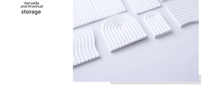 Macro detail of wave and arch shaped plaster storage tray with linear groove texture