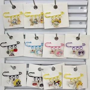 Colorful 6cm enamel safety pins featuring cute cartoon characters on white card display