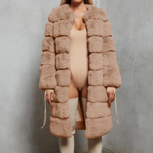 Detail of camel faux fur coat featuring square quilted texture and premium plush fiber
