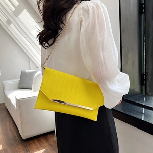 Elegant yellow pleated evening clutch bag with gold metal trim and chain strap on shoulder