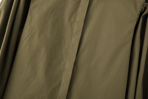 Close-up of military green poplin cotton fabric texture and stitching details