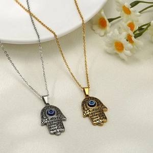 Gold and silver Hamsa Hand necklaces with Evil Eye charms and inspirational engravings
