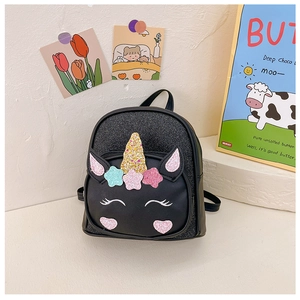 Close-up of black sequined unicorn backpack with golden horn and star details