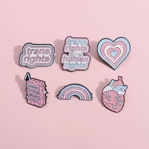 6pcs Transgender Pride enamel pins featuring rainbow hearts and juice boxes set on pink