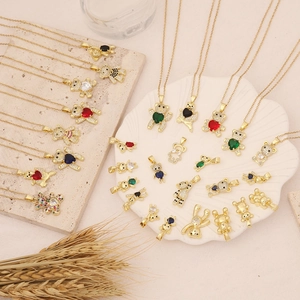 Detailed close-up of colorful bear necklaces with zircon inlays and gold plating