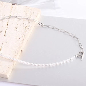 Detailed view of half pearl and paperclip chain necklace with silver OT clasp