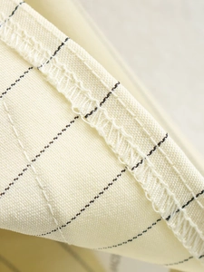 Close-up of the high-quality striped fabric texture and precise stitching on the hemline