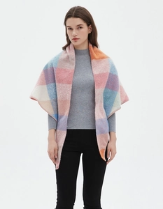 Detailed view of a multi-color plaid triangle scarf wrap worn on a female model
