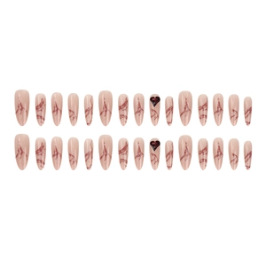Long almond press-on nails with pink marble texture and 3D red heart rhinestone accents