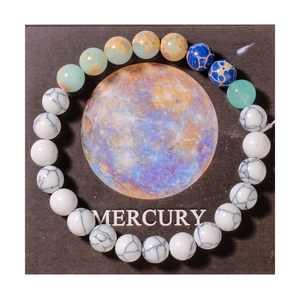 Detail of beaded solar system bracelet with natural stones on a Mercury themed card