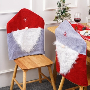Detail of Christmas chair covers featuring gnome-style red hats and plush white beards
