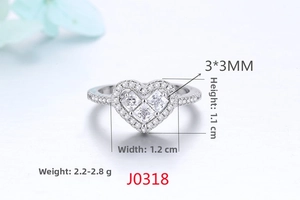 Macro detail of silver heart ring with three square zircons and size measurements