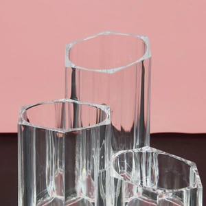 Detailed view of clear acrylic hexagonal makeup brush holder with three-tier compartments