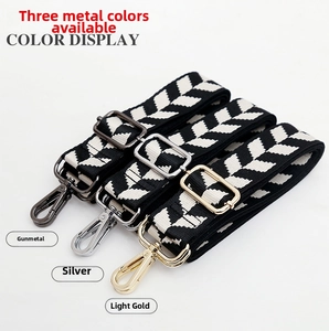 Detail of adjustable jacquard bag straps in black and white chevron pattern with metal buckles