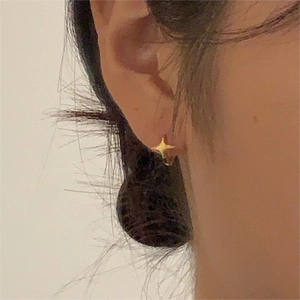 Elegant 925 silver gold star earrings for women worn on ear in a minimalist style