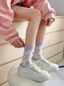 Close-up of cute cartoon dog pattern on light purple and white cotton crew socks