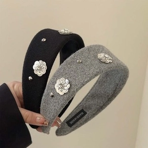 Detail of handmade baroque headbands with silver sequin flowers and metal studs