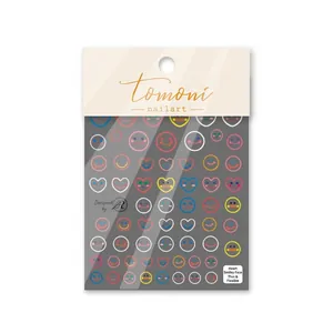 Detail of colorful smiley face and heart nail stickers on thin flexible gray backing