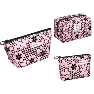 Set of pink fabric cosmetic bags with black floral flocking print and zipper closure