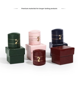 Detail of luxury jewelry boxes with gold swan clasps and textured leather finish
