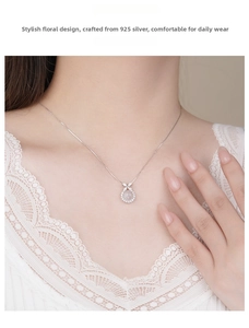 Detail of 925 sterling silver butterfly flower pendant with pink gemstone on necklace