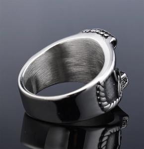 Macro detail of Viking Mjolnir ring showing brushed steel inner band and relief patterns