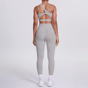 Detail of grey one-shoulder yoga bra and high-waisted leggings set from the back view