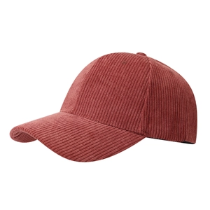 Macro shot of dark brick red corduroy texture and stitching on a baseball cap
