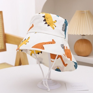 Detail of kids cartoon dinosaur sun hat with adjustable chin strap and soft cotton fabric