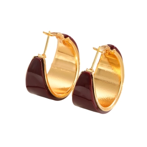 Elegant wide C-shaped gold hoop earrings with burgundy enamel finish on white background