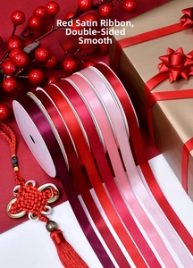 Close-up of red satin ribbons with smooth texture for gift boxes and wedding favors