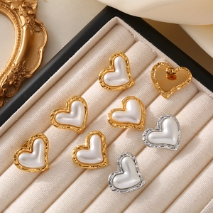 French vintage heart pearl earrings in gold and silver finish on display tray
