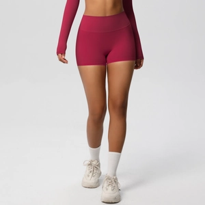 Close-up of high-waisted dark rose red yoga shorts with body-shaping fit and elastic fabric