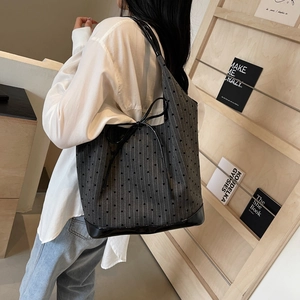 Polka dot canvas bucket backpack with glossy leather base for casual daily use