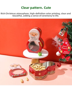 Detailed view of Christmas tin box with Santa pattern and clear window for candy storage